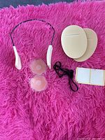 All accessories laid out: enhancer strap, nipple covers, bra pads, garment tape