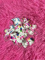 Pile of colorful unicorn head keychains displaying design and quantity