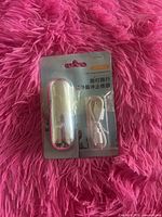 Front view of sealed package showing device and USB cable
