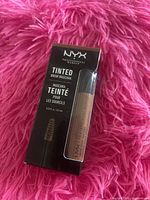 Front of box showing NYX Tinted Brow Mascara tube