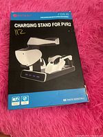 Front of retail box showing image of charging stand for PS VR2