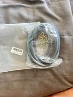 Bagged coil of black rubber seal with barcode sleeve visible