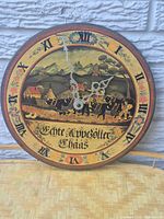 Front view of round wooden wall clock showing full painted dial and hands