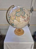 Full view of globe on wood base