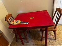 Full view of red-top table with two chairs