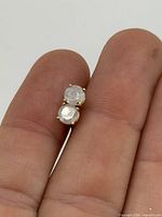 front view of both diamond studs in hand