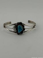 Front view of sterling cuff bracelet showing turquoise stone and design