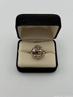 Ring front showing frowning moon face in box