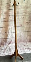 Full view of coat rack showing height, post, and base