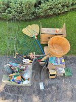 Overall lot view with tomato cage, broom, basket, boots, tote of tools and boxes