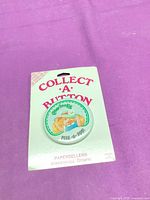 Front view of button attached to backing card