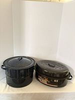 Stock pot and roaster side by side showing size and lids