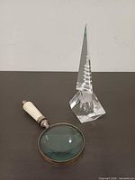 Magnifying glass and crystal perfume bottle full view