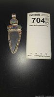 front view of pendant beside lot tag