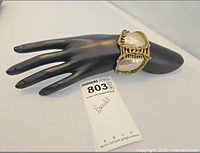 Cuff bracelet displayed on hand form, showing overall shape and size