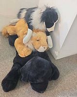 Three stacked plush floor-mat animals showing sizes and colors