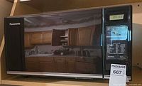 Front view of Panasonic NN-6309 microwave with digital display and control panel