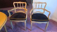 Front view of both chairs showing overall design, wood tone and upholstery