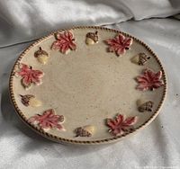 Full view showing plate front, relief leaves and acorns