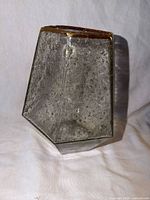 Front angled view showing bubbled glass texture and gold rim