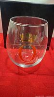 Front view of stemless wine glass showing crown and monogram O decal