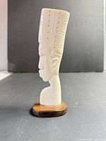 Side view of complete bust on wood base