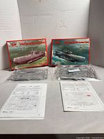 Both boxed kits with sealed sprues, instruction sheets and decal sheets displayed