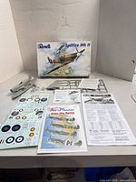 Complete kit contents laid out: box, sprues, loose parts, decals, AeroMaster decal set, instructions