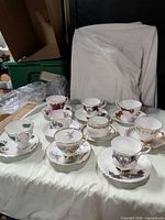 Group shot of nine teacup-saucer sets on table