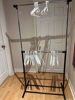 full view of garment rack with hangers attached