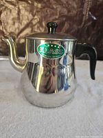 Full view of teapot showing body, spout, handle and lid