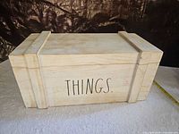 Front view of light wood box with "THINGS." text