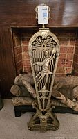 Central brass column with female figure relief and pierced base