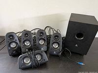 Full set showing subwoofer and five satellites with wiring