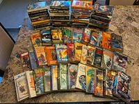 Wide overview of all paperback novels stacked and spread on table