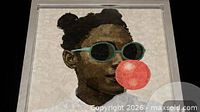 Close view of the artwork showing portrait details, sunglasses, pink bubble