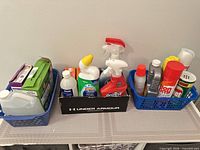 Overview of all baskets and tray with assorted cleaning items