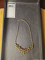 Full necklace laid flat showing overall design and chain