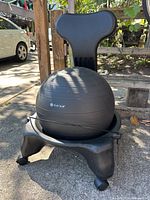 Full view of balance ball chair showing ball, base, casters and backrest