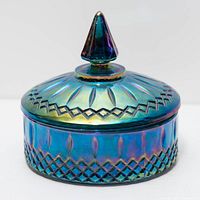 Covered candy dish front view showing iridescent finish and lid finial