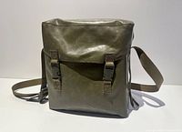 Front view of olive drab vinyl military shoulder bag with flap closed and buckles visible