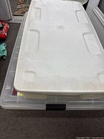 Top view showing white lid on clear tote