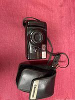Front view of Samsung AF Zoom 770 camera with strap and case visible