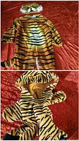 Back view of tiger costume showing tail, hood with ears