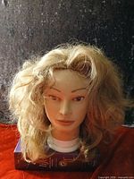 Front view of golden blonde wavy wig on mannequin head