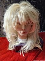 Front view of blonde wig on mannequin head