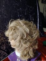 Left side profile of light brown wavy wig on mannequin head