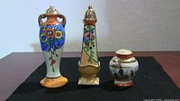 Front view of three ceramic Japanese salt and pepper shakers