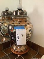 Jar with lid on wooden stand showing overall form and size reference
