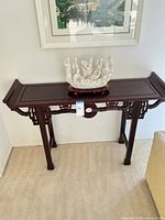 Full view of console table with porcelain figurine displayed on top